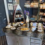 Gallery 1 - leopard tablecloth with china teacups and a tray of snacks