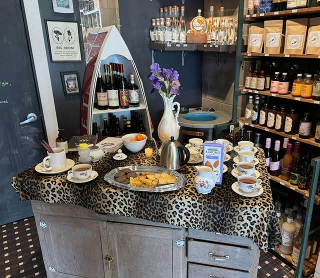 Gallery 1 - leopard tablecloth with china teacups and a tray of snacks